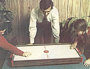 Family playing Air Hockey